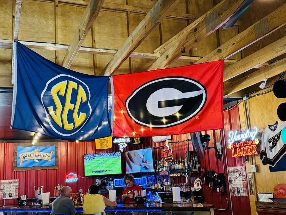 SEC and UGA flags over the Rolling Chefs bar